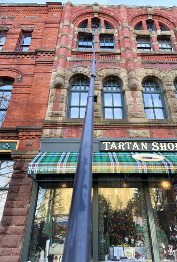 Cleaning high window with water fed Pole downtown Charlottetown